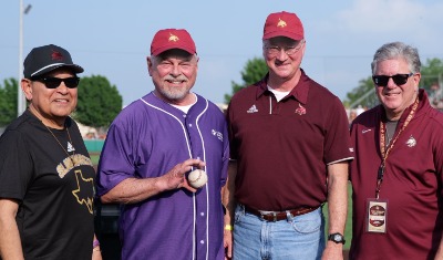 Individuals Posing for a Picture at a Baseball Game